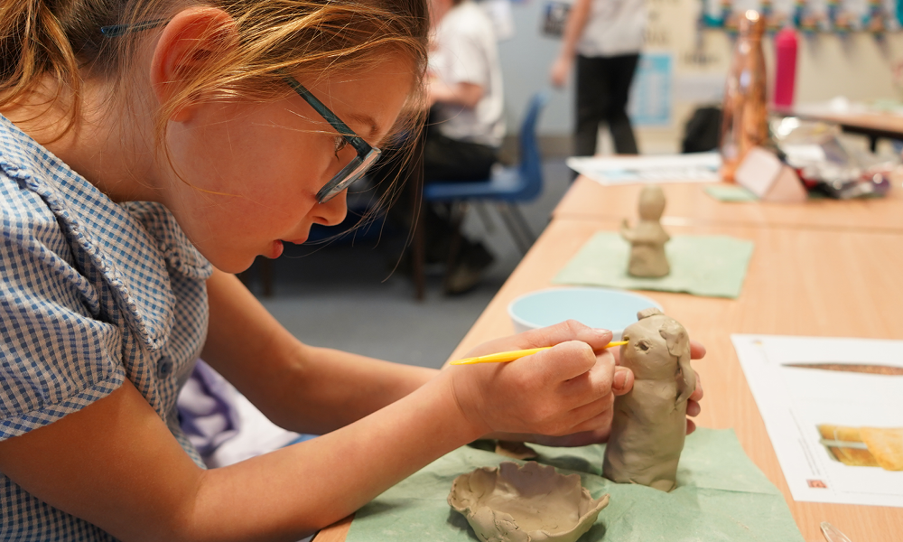 Child in Year 4 creating a Shang Dynasty artefact replica.